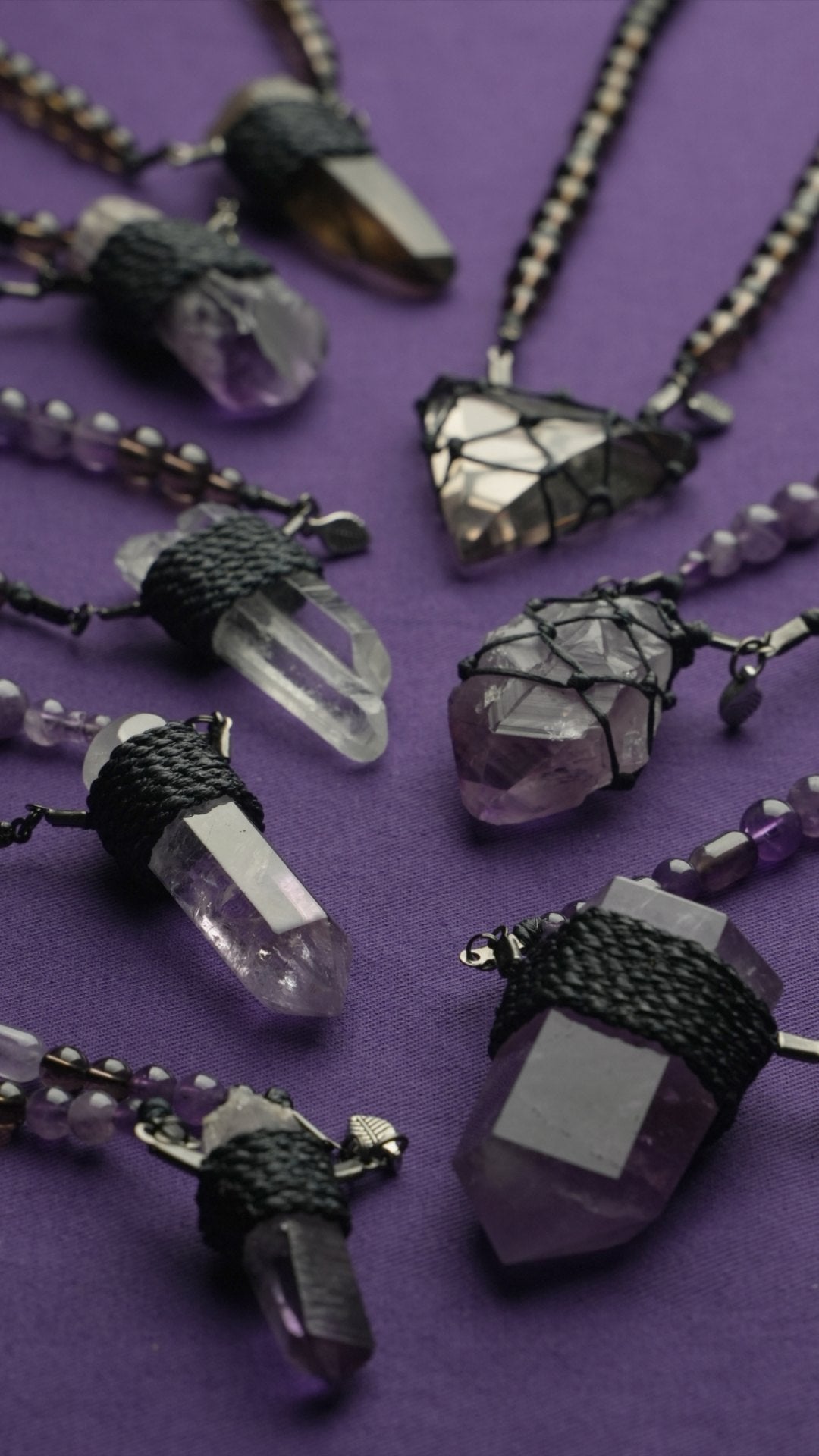 Clink pendants fanned across purple cloth